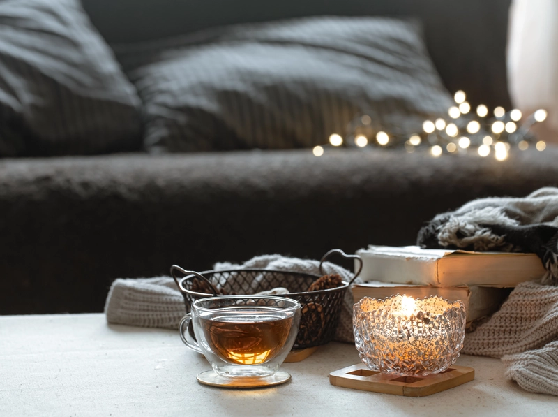 Finding hygge at home with a warm drink and candlelight