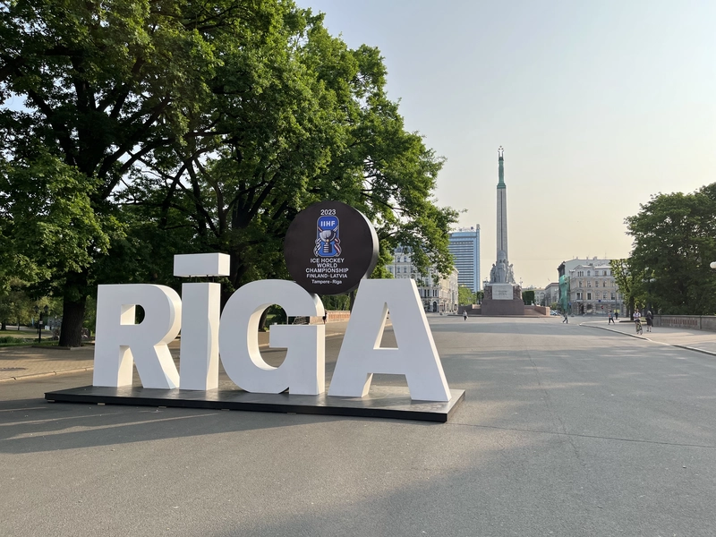 Riga sign with Freedom Monument in the background